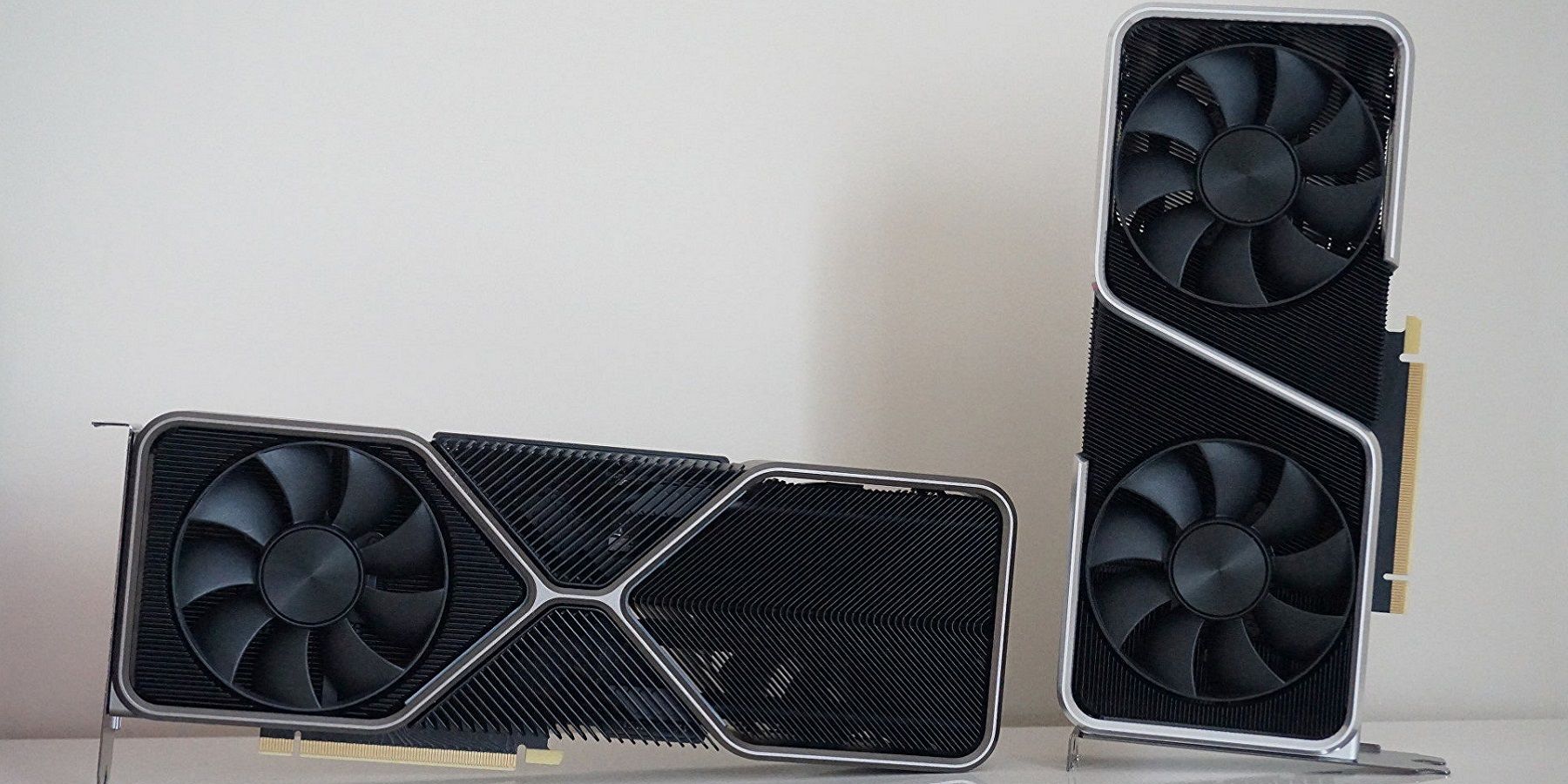 A photo of a couple of Nvidia GPUs, one stood up, one on its side.