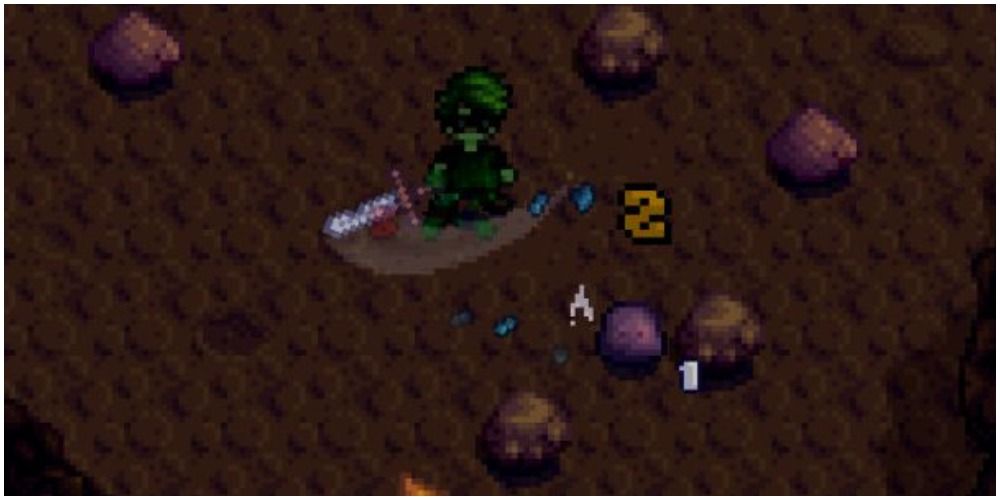 stardew valley player fighting slime in dark cave