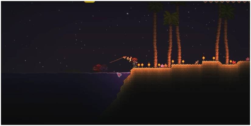terraria player fishing up a blood eel