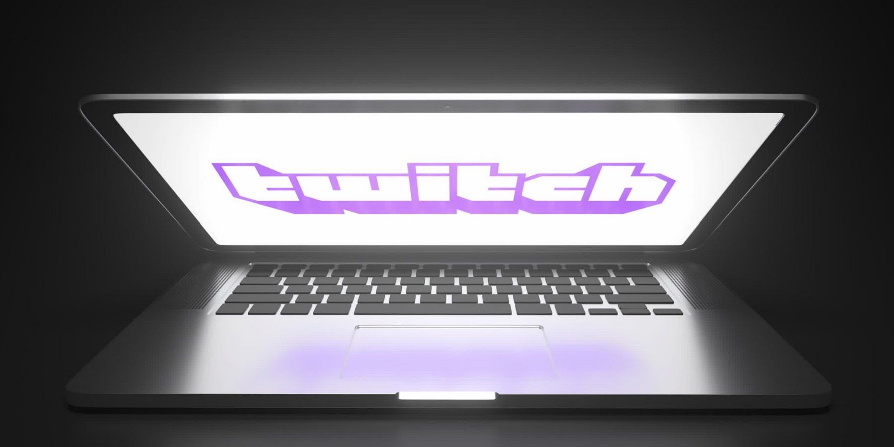 A photo of a half-closed laptop with the Twitch logo on the screen.