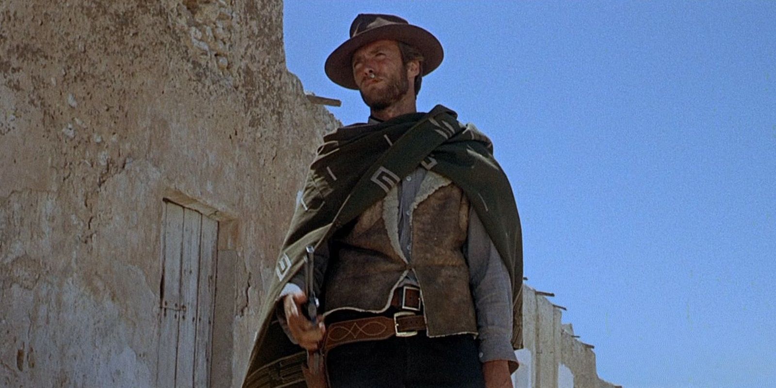 Clint Eastwood holding a gun in A Fistful of Dollars