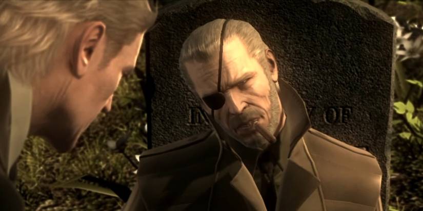 Big Boss at gravestone with cigar.