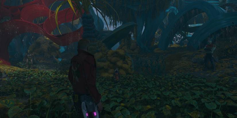 the whole guardians team in a jungle with red leaves overhead on the left 