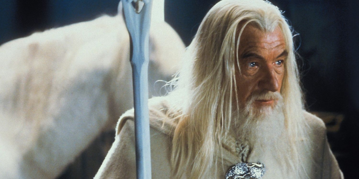 Gandalf the White holding his staff and standing next to his horse Shadowfax