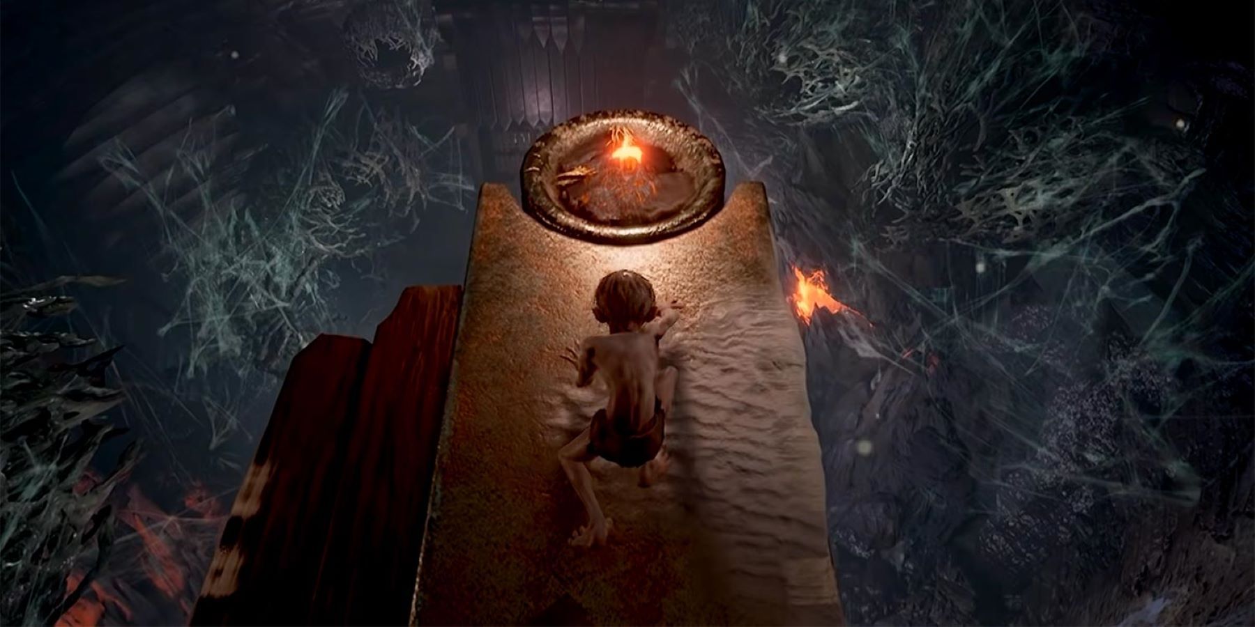 Gollum crawling towards a burning torch in Mirkwood in The Lords of the Rings: Gollum