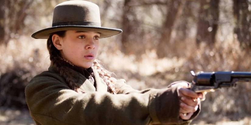 Hailee Steinfeld holding a gun in True Grit