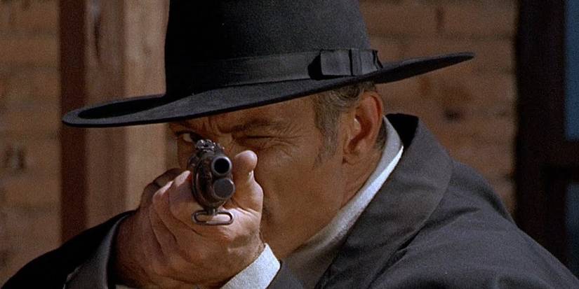 Lee Van Cleef holding a rifle in For a Few Dollars More