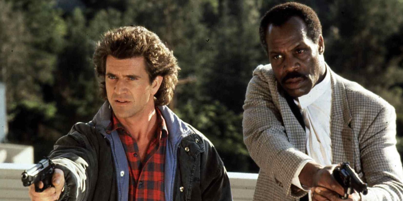Mel Gibson and Danny Glover holding handguns in Lethal Weapon