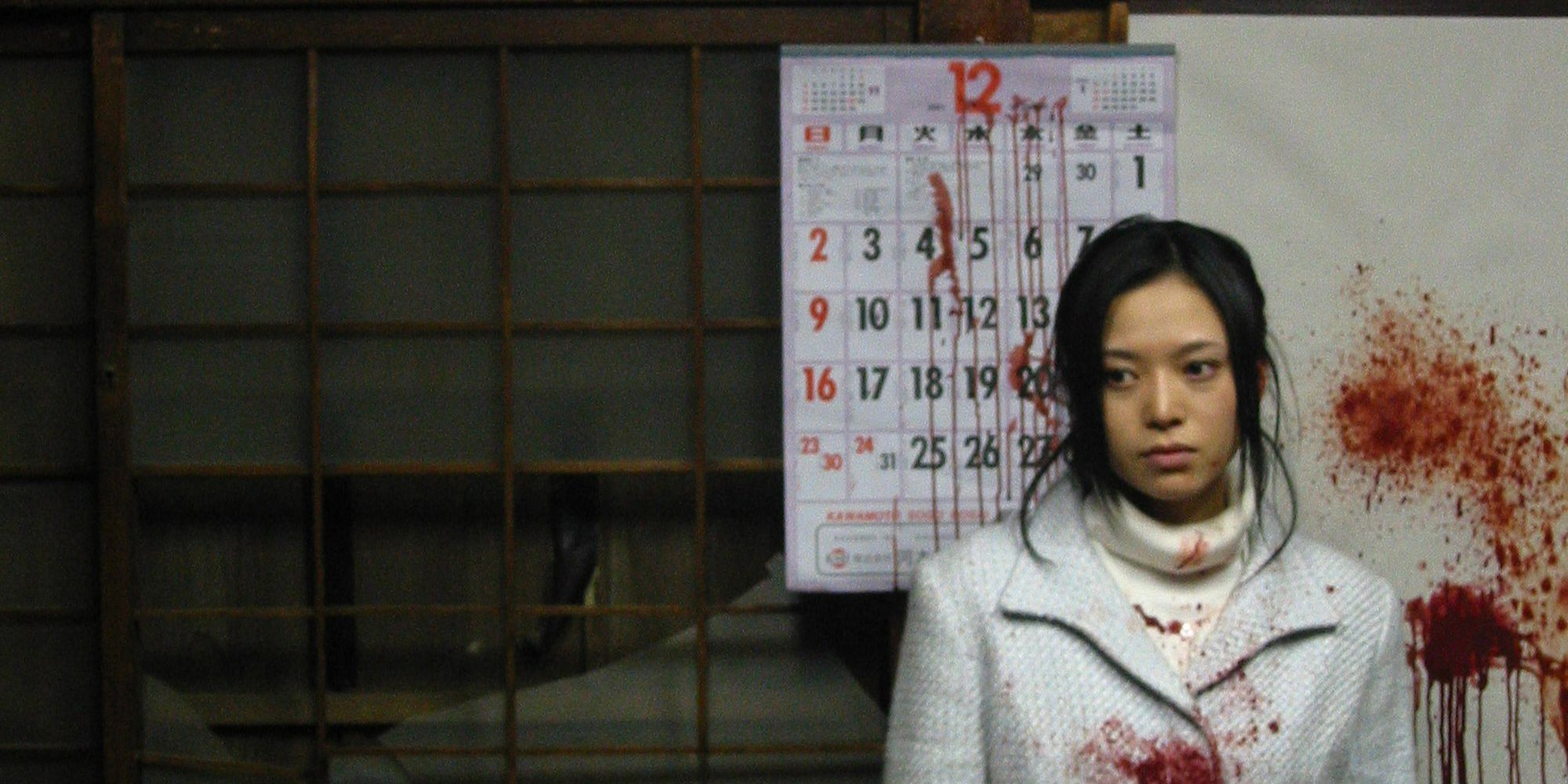 A girl stands in front of a blood-splattered calendar in Noriko's Dinner Table