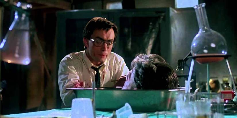 Reanimator scientist looks at head on desk
