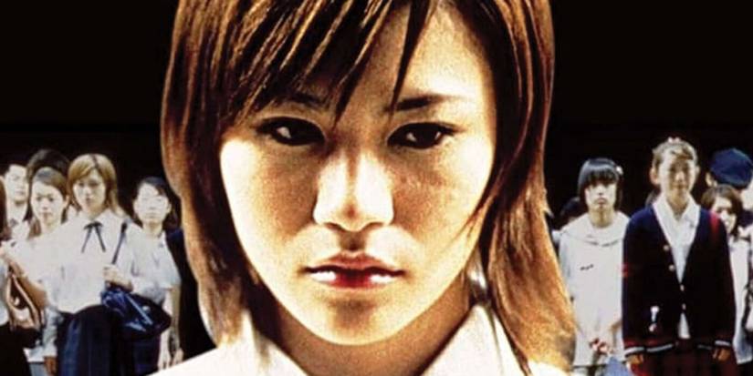 Close-up of a girl flanked by other students in Suicide Club