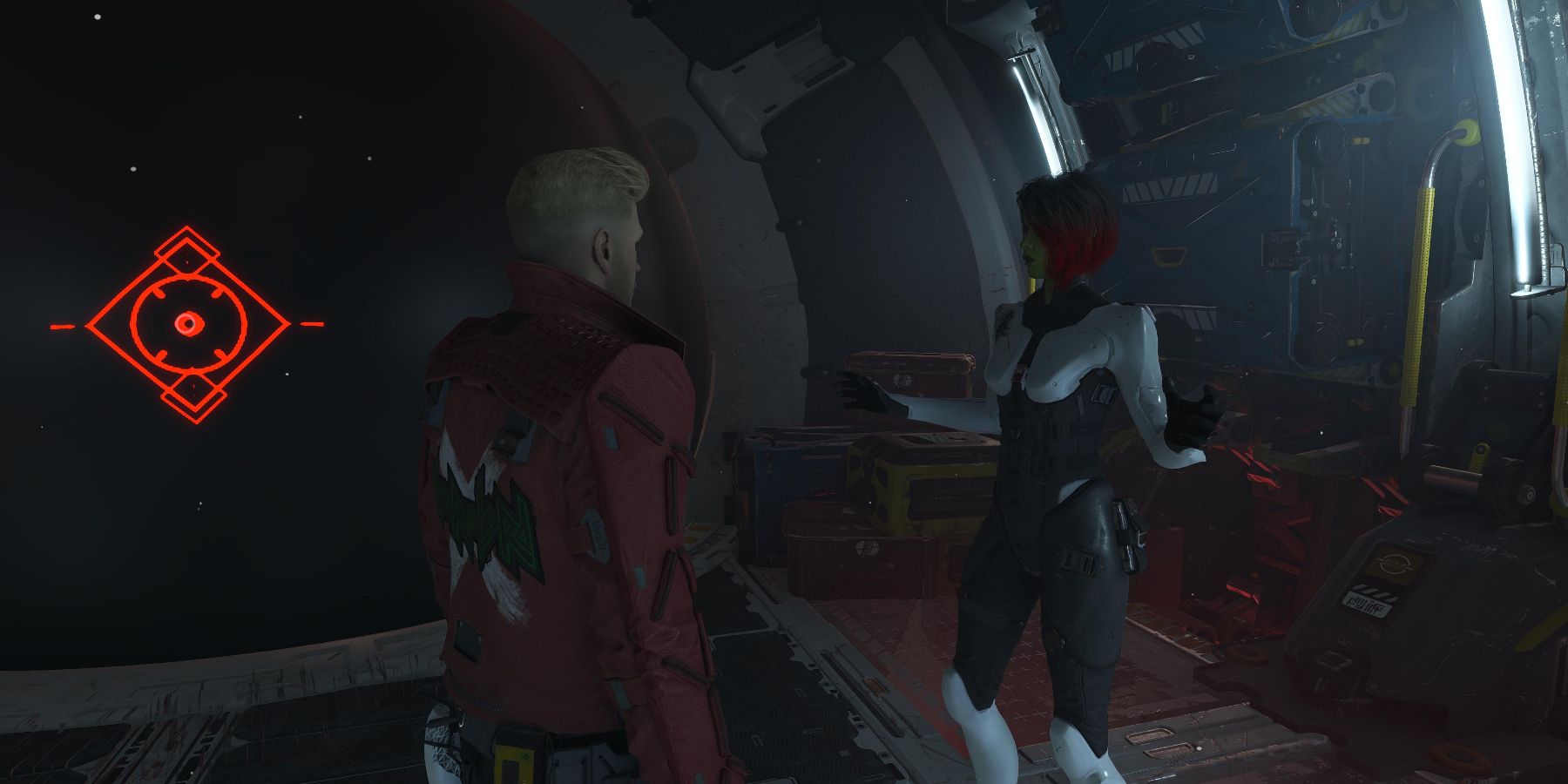 star-lord in a red leather jacket talks with gamora in white and black armor while in the milano cargo hold