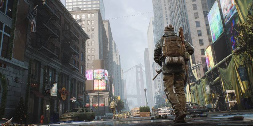 Two characters in The Day Before walk through a city street in an abandoned city.