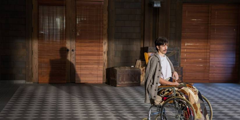 Wallace sits alone in a wheelchair in Tusk