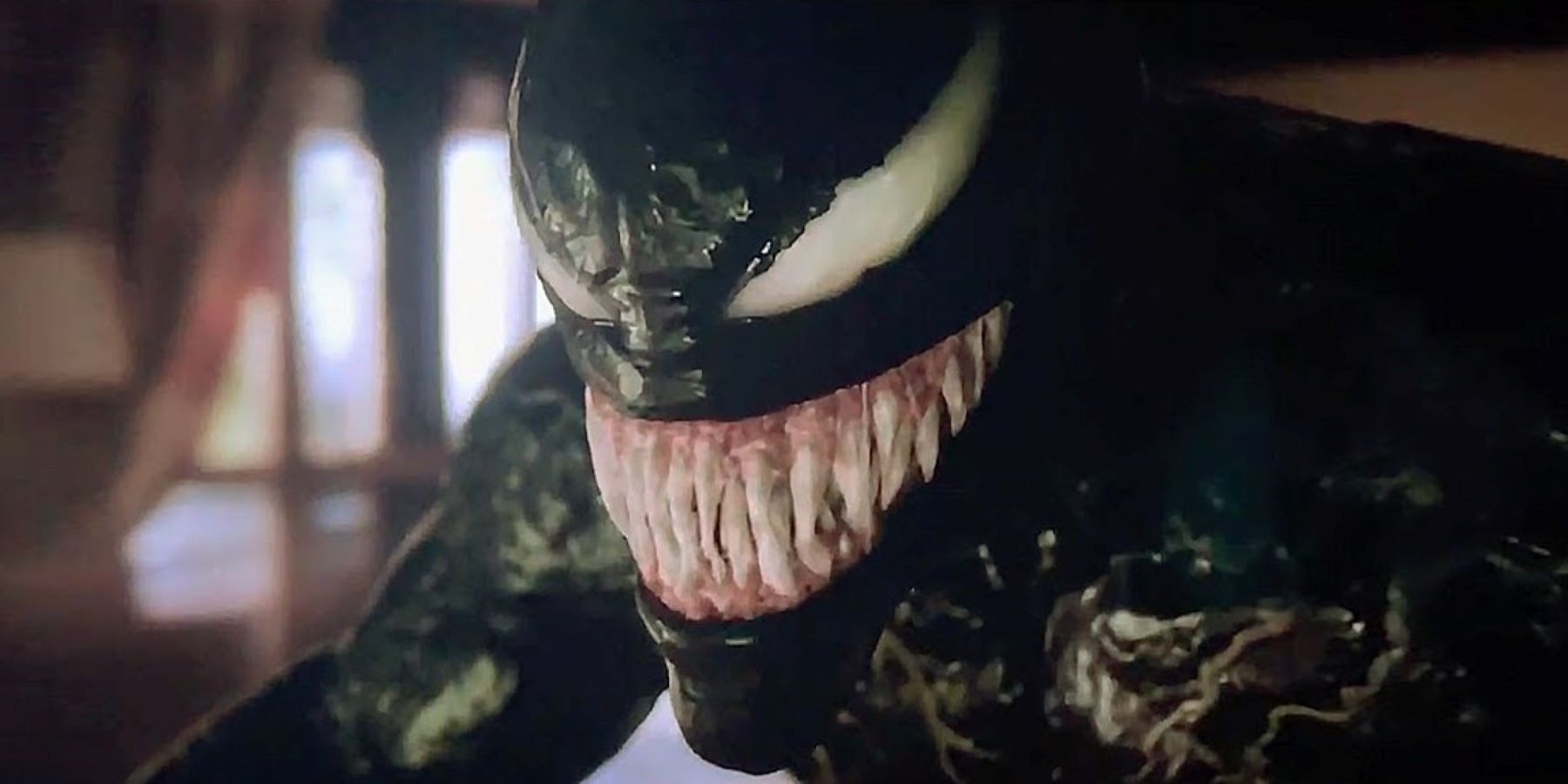 Venom grinning and baring his teeth in the post-credits scene for Venom: Let There Be Carnage