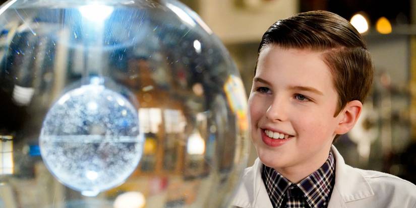 Young Sheldon smiling at an orb in the lab in Young Sheldon