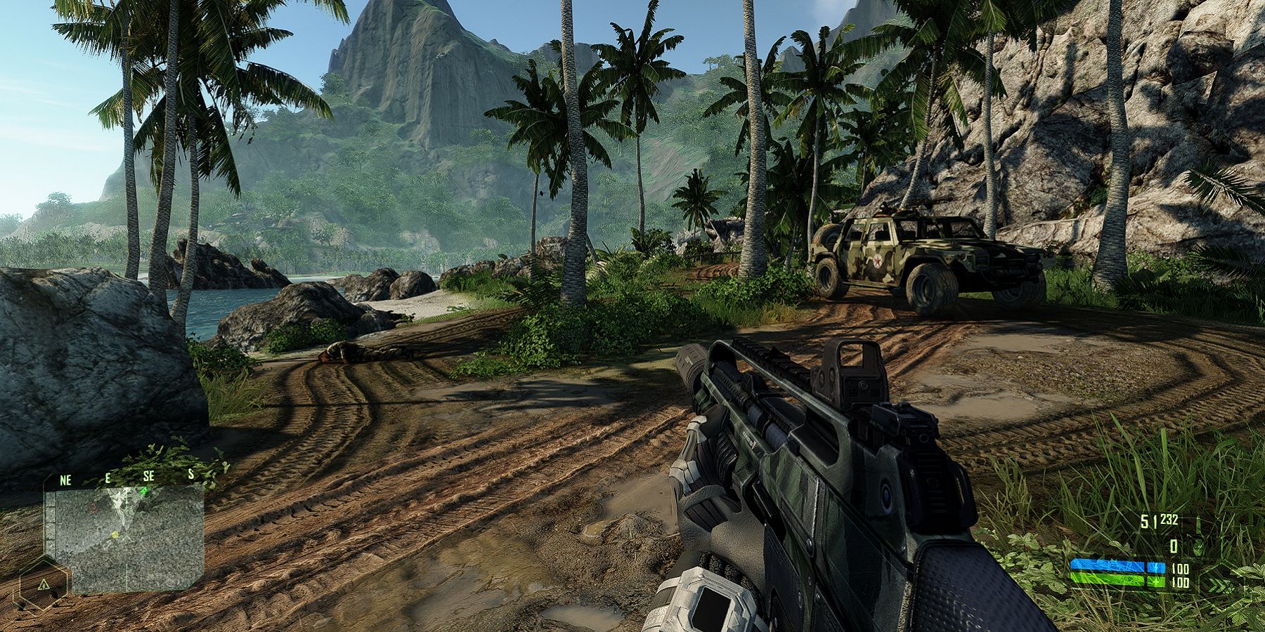 A screenshot from Crysis showing a dirt road and a mountain in the far distance.