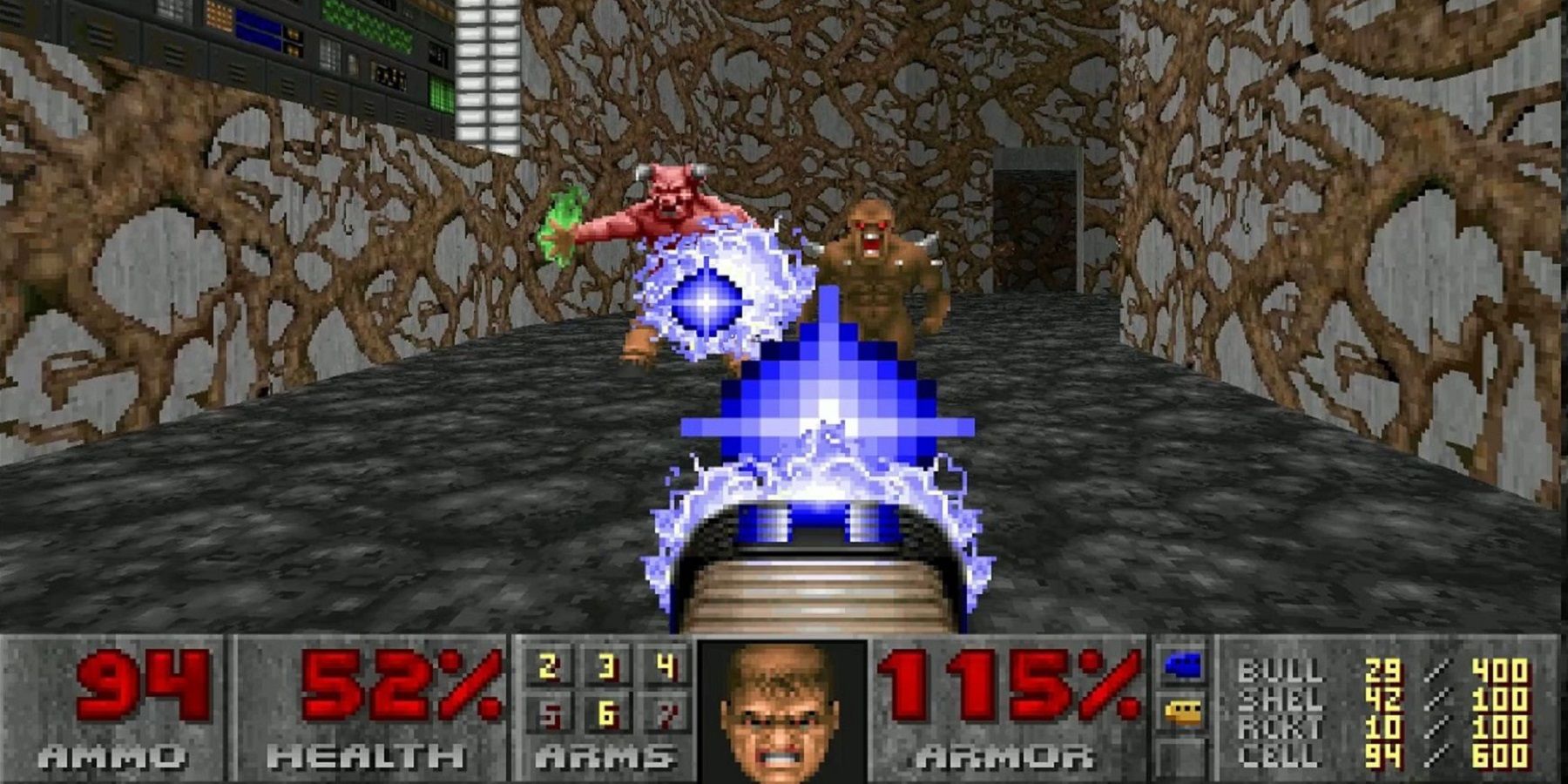 A screenhot from the original Doom showing the plasma gun being fired at an imp and Baron of Hell.