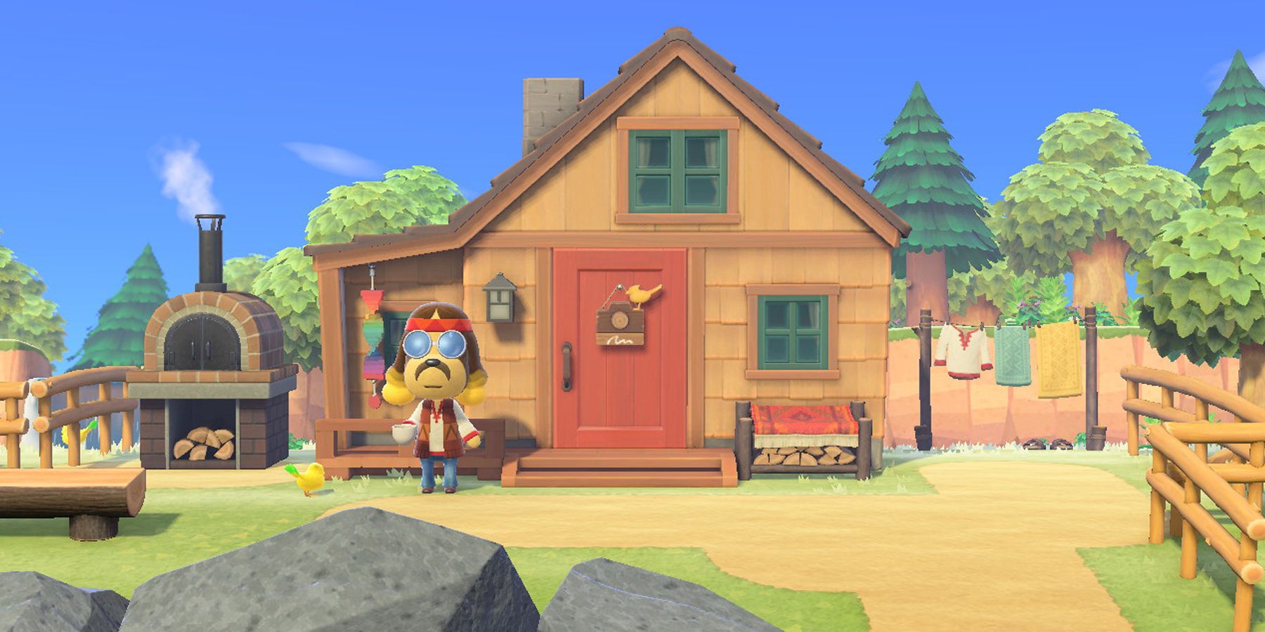 Harvey stands in front of his house and photo studio on Harv's Island in Animal Crossing: New Horizons.