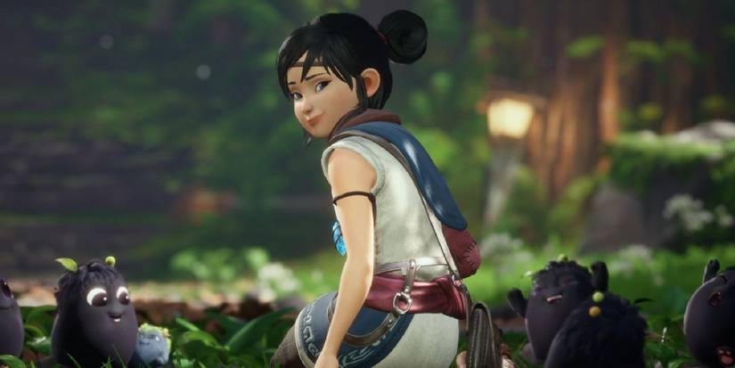 Screenshot of Kena looking to the camera with Rots behind her in Kena: Bridge of Spirits.