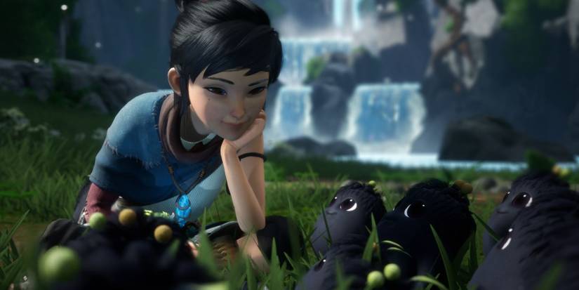 Screenshot of Kena from Kena: Bridge of Spirit talking to her Rots sidekicks.