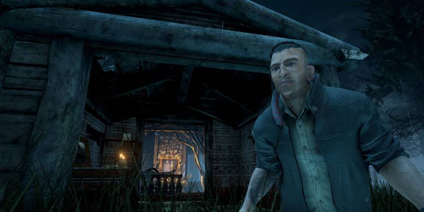 A survivor stands outside a building in Dead by Daylight