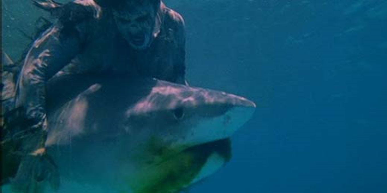 A zombie fighting a shark in Zombie Flesh Eaters