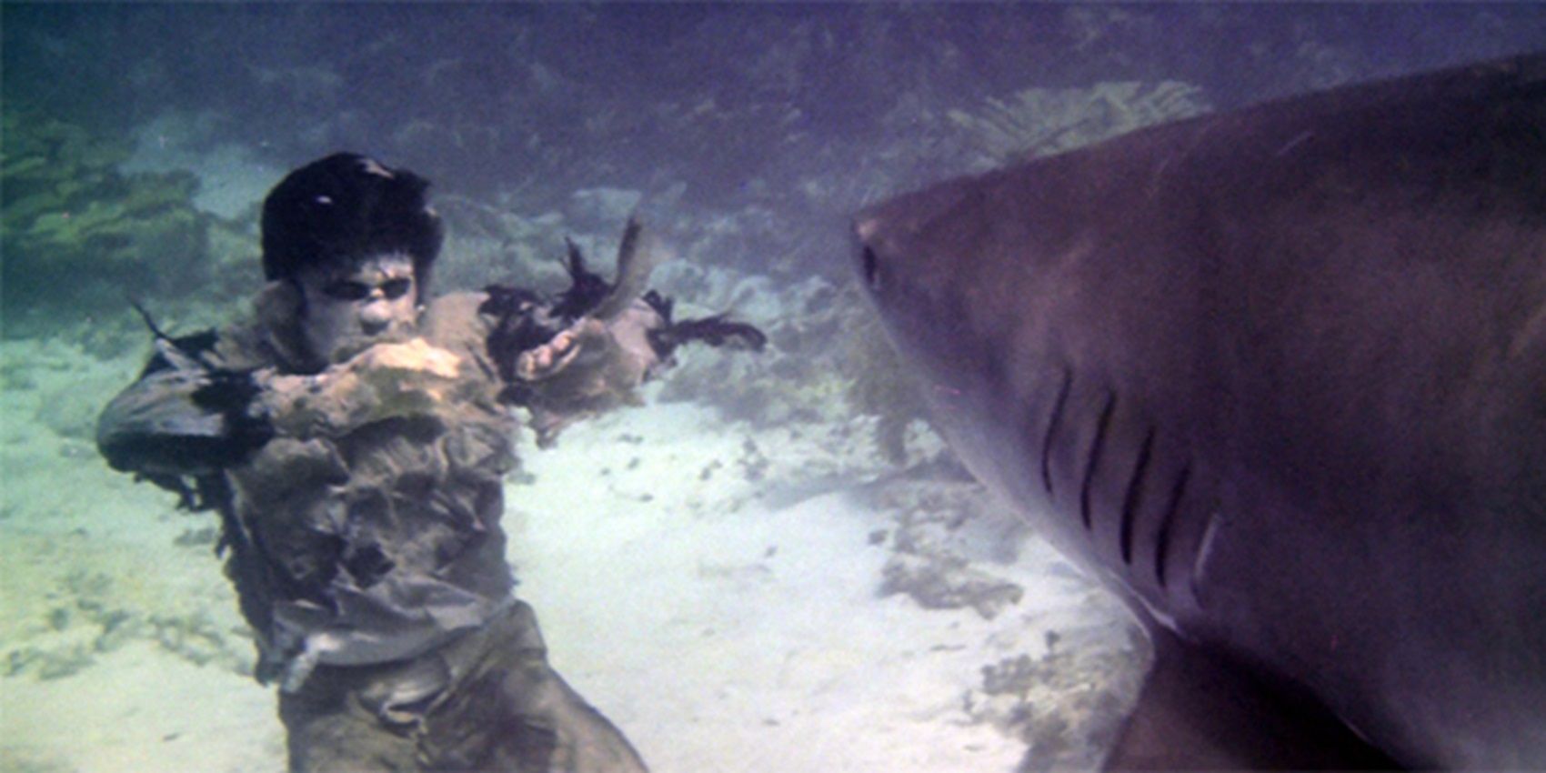 A-zombie-underwater-with-a-shark-in-Zombie-Flesh-Eaters-1