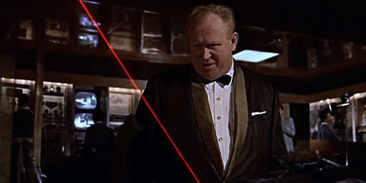 Auric Goldfinger watches a laser beam going between Bond's legs