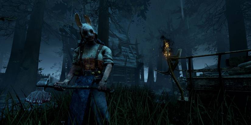 Huntress stands outside a shack in Dead by Daylight