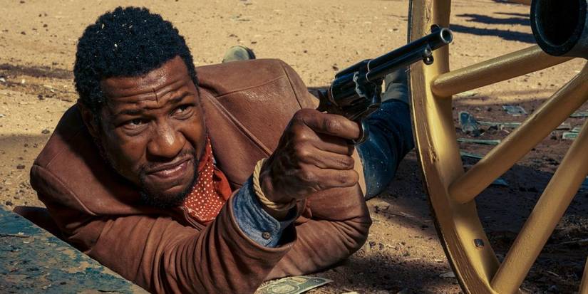 Jonathan Majors with a revolver in The Harder They Fall