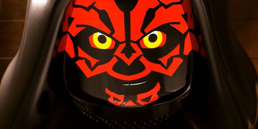 Darth Maul with his hood up smirking at the camera in LEGO Star Wars: The Skywalker Saga