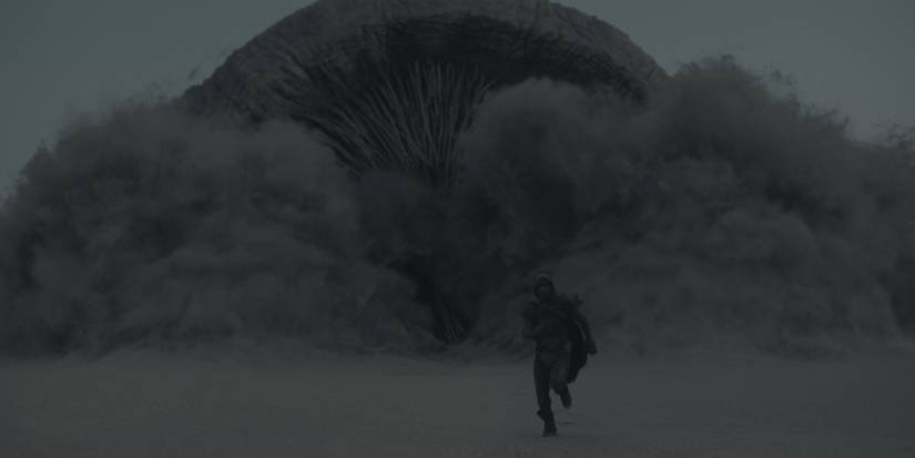 Paul fleeing from a sandworm in Dune