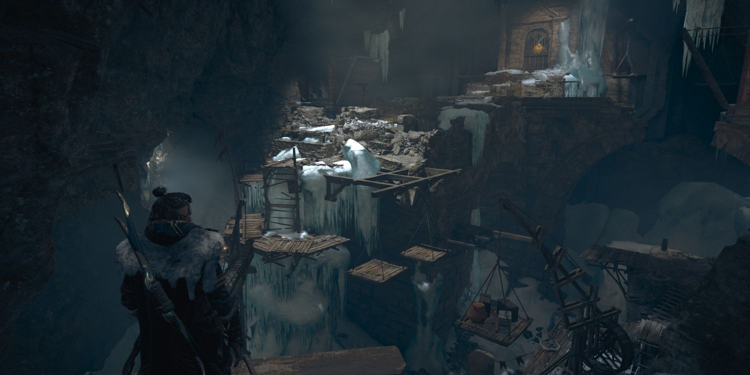 eivor standing in front of a large cavern with multiple platforms on different levels