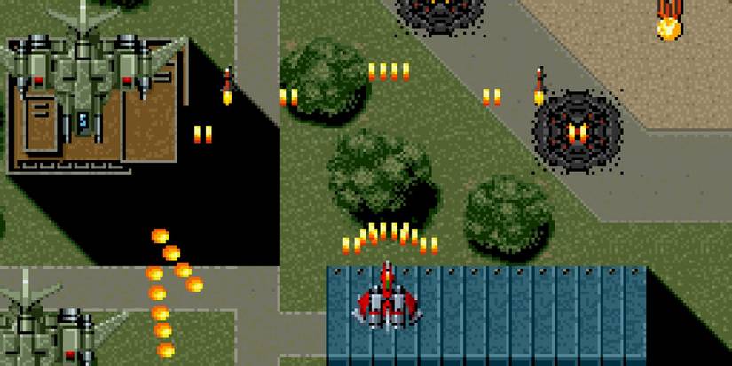 Raiden Trad SNES spraying projectiles forward over airforce military base stage