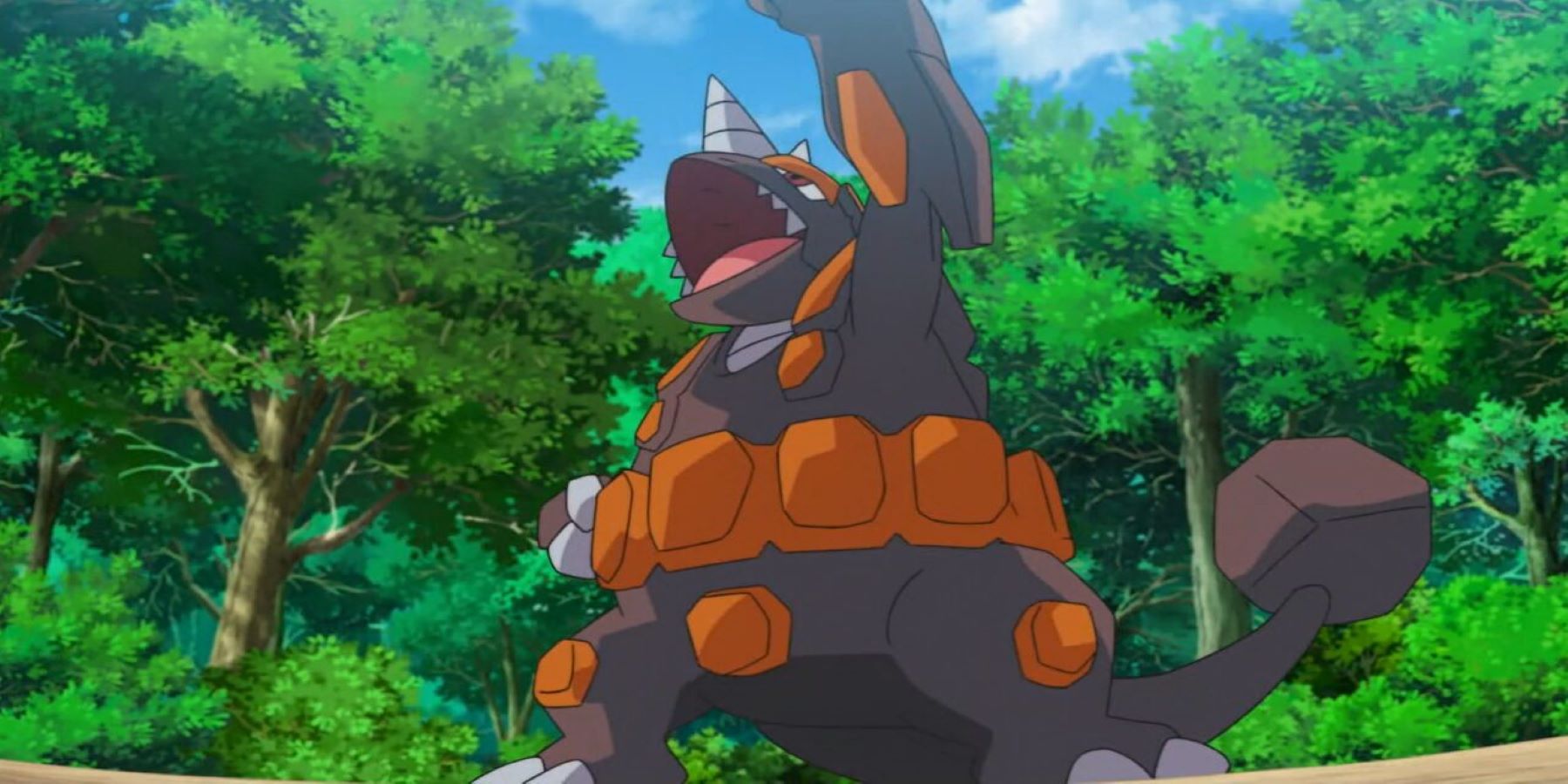 A Rhyperior standing in a forest and raising one arm triumphantly in the Pokemon anime