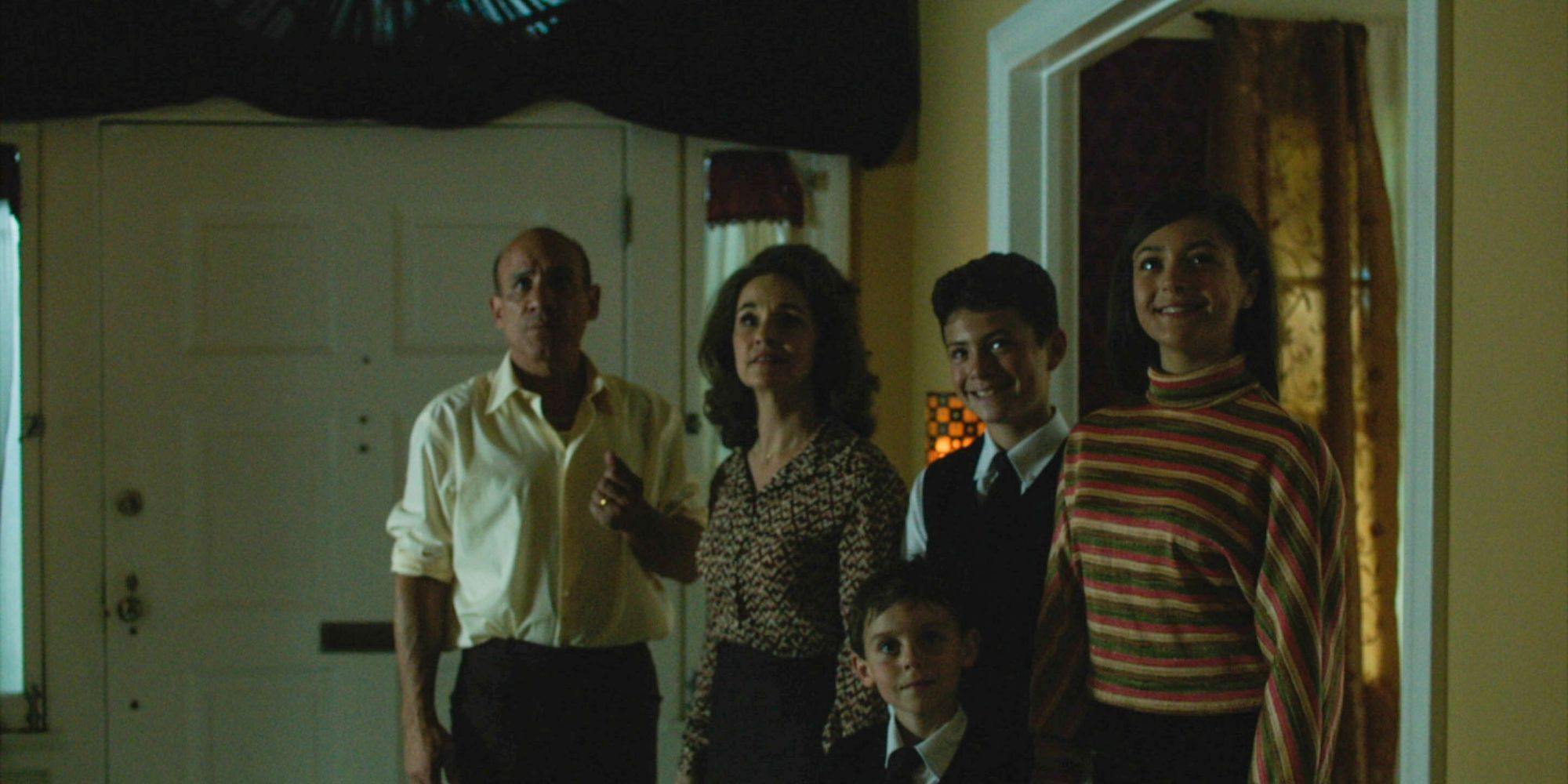 Five characters standing in the Amity house in The Amityville Murders