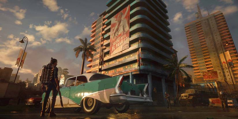 far cry 6 player looking at a car with buildings in the background 