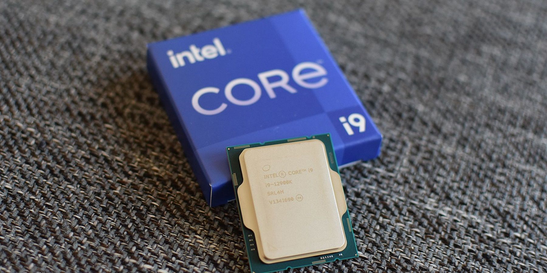 A photo of the Intel i9-12900k processor leaning againts its display box.