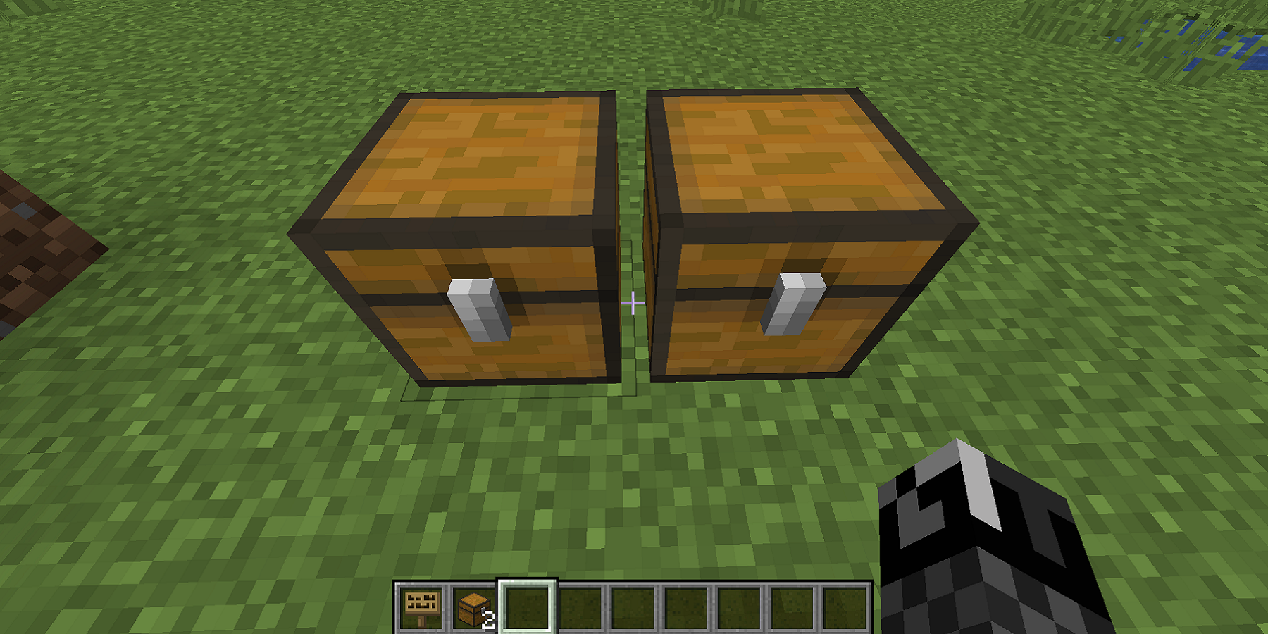 A screenshot from Minecraft showing two small chests next to each other, somehow.