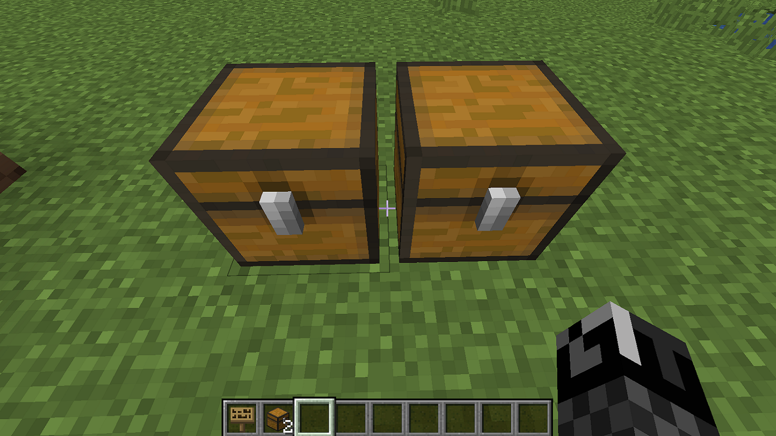 A screenshot from Minecraft showing two small chests next to each other, somehow.