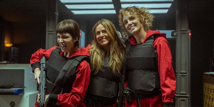 money heist Tokyo, Lisbon, and Stockholm smiling in jumpsuits and vests