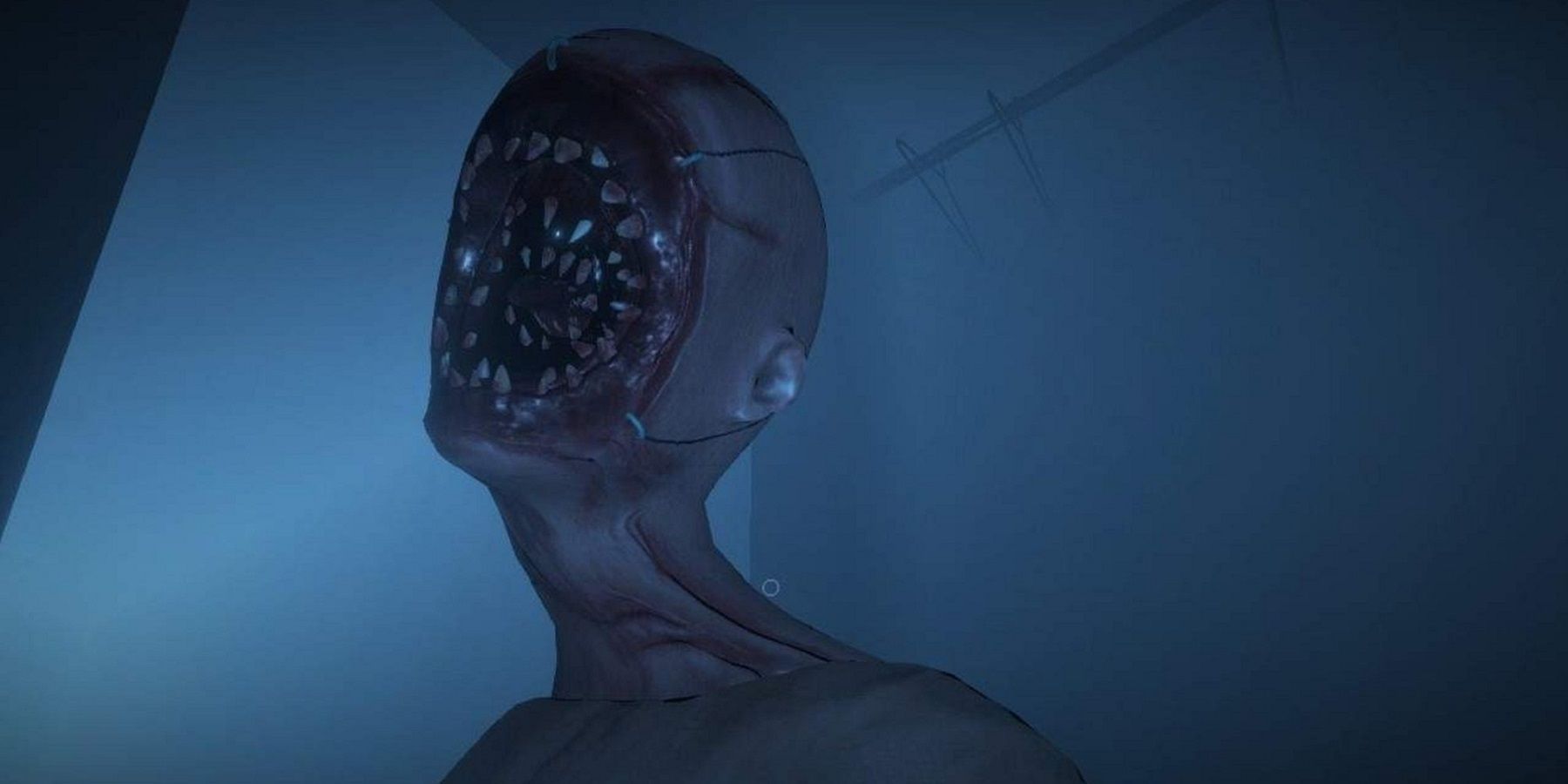 Screenshot from Phasmophobia showing a close-up of a terrifying creature with vast amounts of teeth instead of a face.