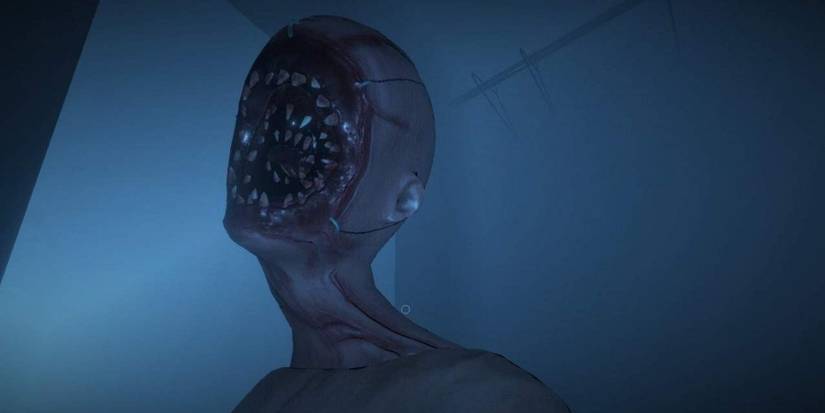 Screenshot from Phasmophobia showing a close-up of a terrifying creature with vast amounts of teeth instead of a face.