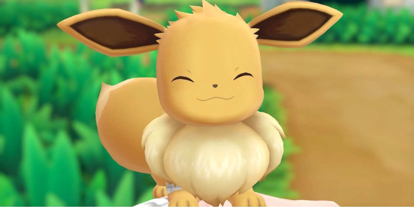 pokemon let's go eevee smiling against grassy background