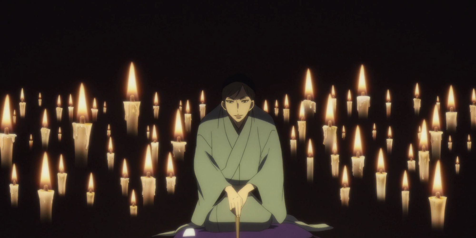 A character from Shouwa Genroku Rakugo Shinjuu kneeling, surrounded by candles