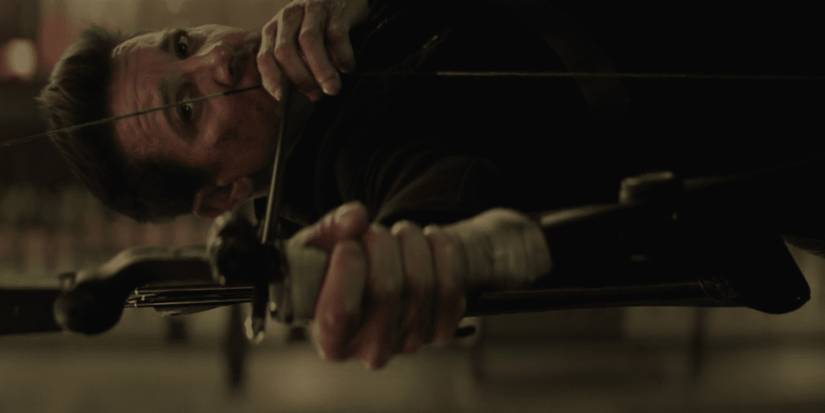 Clint shoots an arrow while jumping through the air in Hawkeye