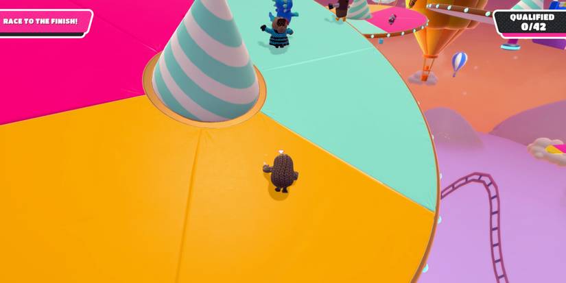 a fall guy in brown cloth lands on a tilted platform 