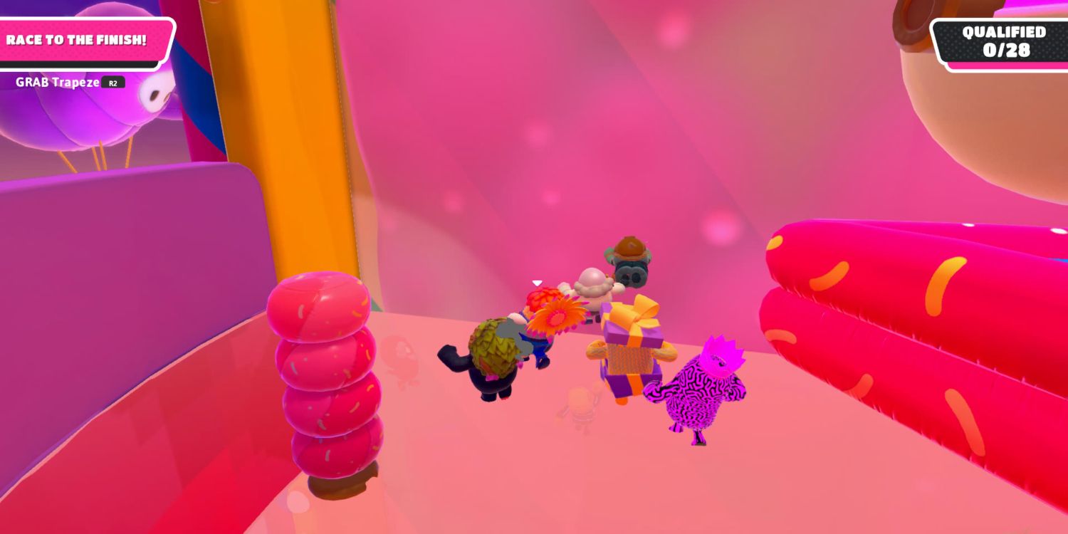 a group of fall guy beans running toward a ledge with pruple slime on the opposite wall