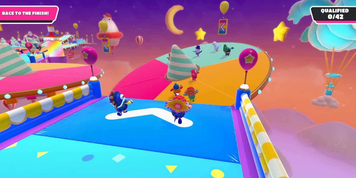 a fall guy bean in a colorful costume running toward a tilting platform with other players on it